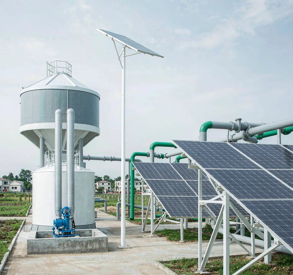 District solar water pumping station with multiple solar arrays, elevated tanks and distribution pipes